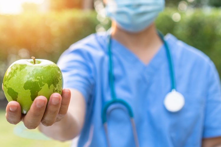 Hand holding an apple